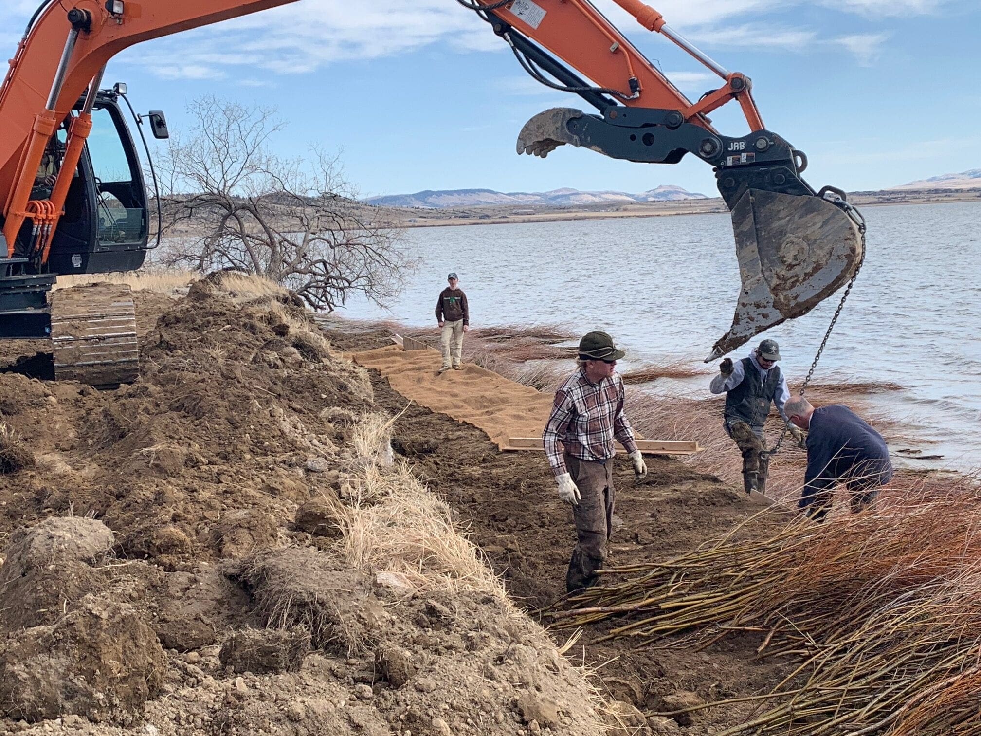 Lewis and Clark Conservation District staff and chairman and other volunteers helping on a double willow soil lift, Lake Helena, Montana